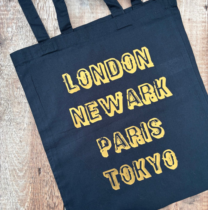 London Newark Paris Tokyo Phrases Tote Bag