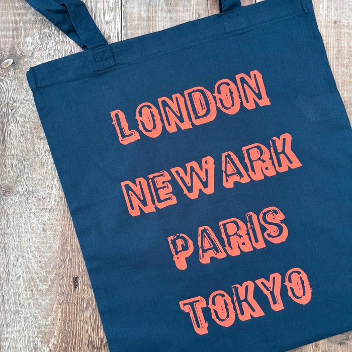 London Newark Paris Tokyo Phrases Tote Bag